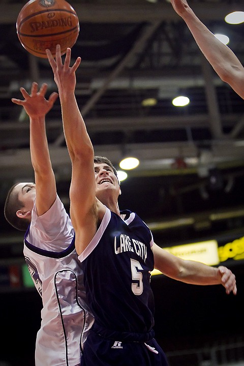 &lt;p&gt;Lake City High's Chris Wheelock slips past Ryan Skurdal from Rocky Mountain High for a layup Friday at the state 5A boys basketball tournament at Idaho Center in Nampa. The T-Wolves were eliminated from the tournament after the 72-52 loss to the Grizzlies.&lt;/p&gt;