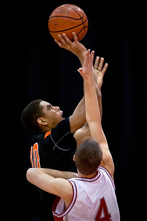 &lt;p&gt;Post Falls High's Shawn Reid puts up a shot in front of Madison High's Rhett Robison during Friday's game at the state 5A boys basketball tournament at the Idaho Center in Nampa.&lt;/p&gt;