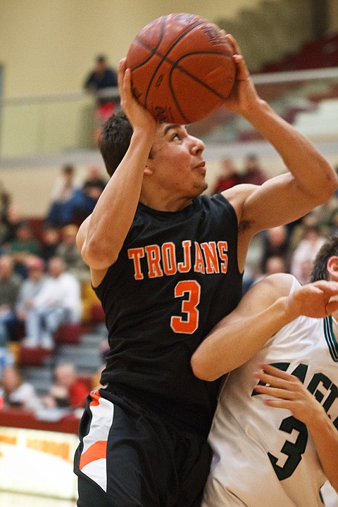 SHAWN GUST/Press

Trojans guard Damon Gonzalez puts up a score to help Post Falls win the consolation trophy at the State 5A basketball tournament.