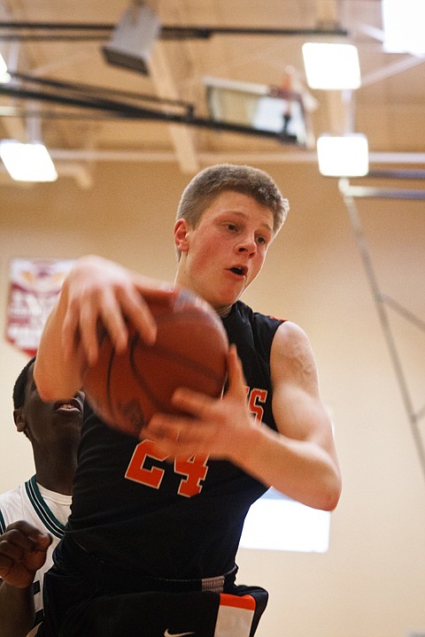 SHAWN GUST/Press

Post Falls' Michael Hillman gets a rebound against Eagle High School.