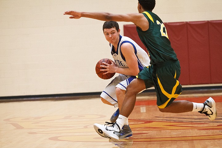 SHAWN GUST/Press

Coeur d'Alene High's Jake Matheson redirects Borah's Isaiah Wright in the first quarter in Nampa.