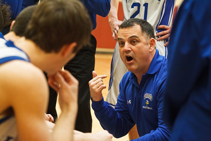 SHAWN GUST/Press

Coeur d'Alene High School boys head basketball coach Kent Leiss offers some encouraging words to his players in the final minutes of Saturday's game against Borah High.