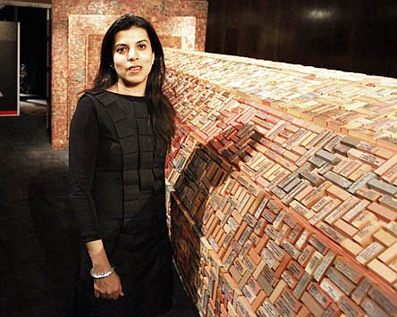 &lt;p&gt;Artist Reena Saini Kallat poses with a piece made of rubber stamps bearing addresses of missing monuments and fragments of poems and phrases on architecture and loss from her &quot;Falling Fables&quot; series as part of the Kennedy Center's &quot;Maximum India&quot; exhibit in Washington, Wednesday, March 2, 2011.&lt;/p&gt;