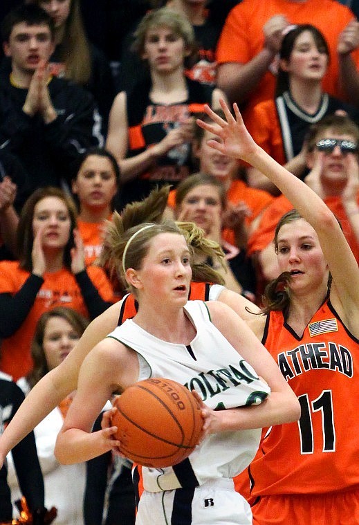 Glacier's Rachel Cutler looks for an open teammate while guarded by Flathead's Sam Thompson during a game on February 5 at Glacier High School.