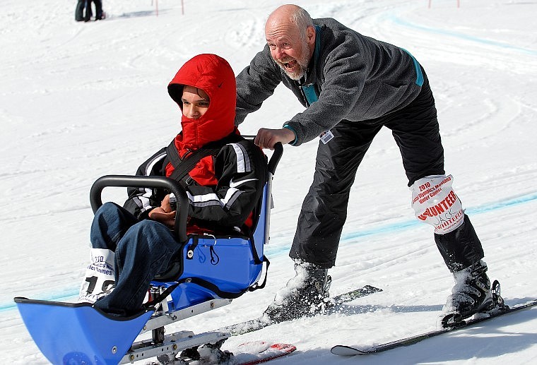 Jack Klovstad steers Kenny &#147;Ralph&#148; Bullcalf of Browning at the end of their Alpine Sit Ski run on Monday.