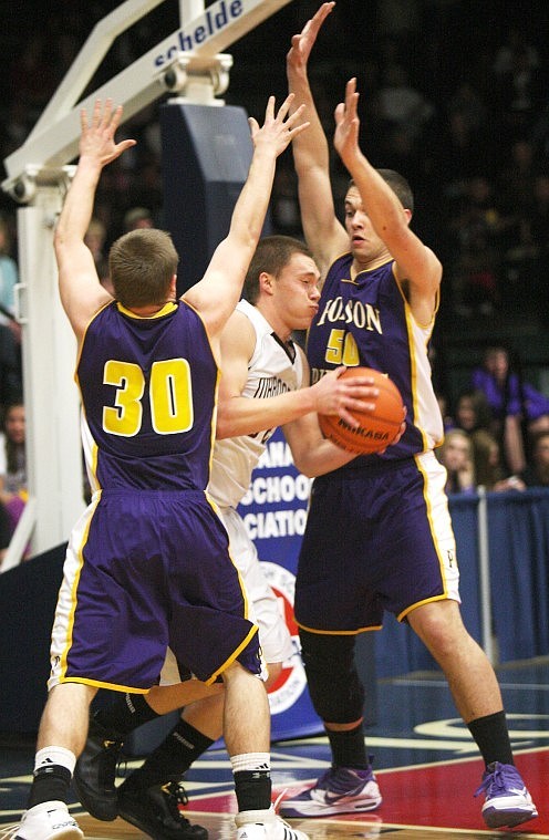 Polson's Tim Rausch and Tyler Krell cage Butte Central's Jonathan Richards under the basket Friday night during their semi finale game in the Butte Civic Center.