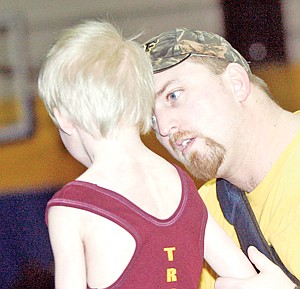 &lt;p&gt;Coach Josh Chapel offers a few words of advice to Peewee wrestler Lukas Fritts Saturday at the Little Guy Wrestling Tourney.&lt;/p&gt;