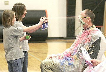 &lt;p&gt;Plains third graders Skylar Bergstrom and Mykenzi Blood silly-string Principal Jim Holland on Friday at the celebration assembly for I Love To Read Month for Plains School. Top readers from each grade had the chance to silly-string both Holland and Superintendent Thom Chisholm.&lt;/p&gt;