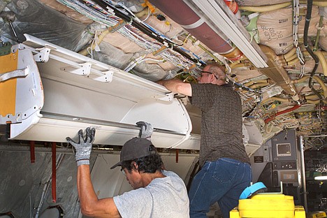 &lt;p&gt;This undated photo provided by American Airlines parent company AMR, shows workers installing larger bins for carry-on luggage on a Boeing 737, in Tulsa, Okla. Fliers can stop sharpening their elbows. Overhead bins are getting bigger. (AP Photo/AMR)&lt;/p&gt;