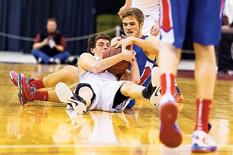 &lt;p&gt;Post Falls High School&#146;s Blake McLean battles with Nampa High School&#146;s Kooper Wilcox for a loose ball in the first period of the state 5A boys basketball tournament Thursday at the Idaho Center in Nampa. To order prints go to http://cdapress.com/photojournalism.&lt;/p&gt;