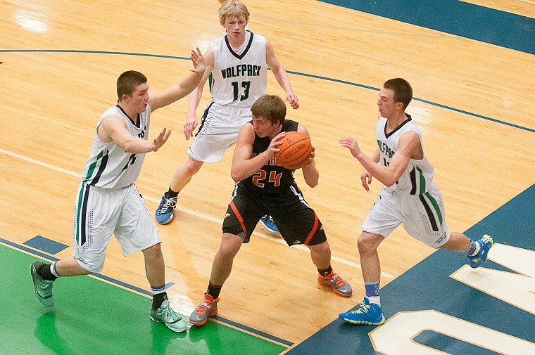 &lt;p&gt;Flathead junior Trae Habel (24) is surrounded by Glacier defenders Friday night during the first half of Glacier's victory over Flathead at Glacier High School. March 7, 2014 in Kalispell, Montana. (Patrick Cote/Daily Inter Lake)&lt;/p&gt;