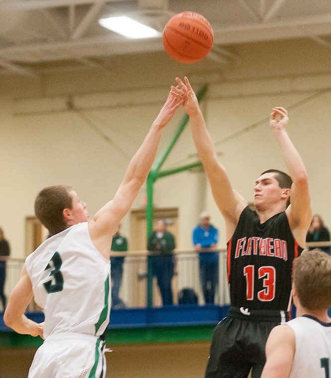 &lt;p&gt;Flathead senior Blaine Newman (13) shoots over Glacier junior wing Sam McCamley (3) Friday night during the second half of Glacier's victory over Flathead at Glacier High School. March 7, 2014 in Kalispell, Montana. (Patrick Cote/Daily Inter Lake)&lt;/p&gt;