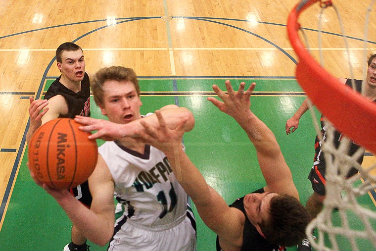 &lt;p&gt;Glacier senior guard Evan Epperly (10) goes up for a shot over Flathead senior Blaine Newman (13) Friday night during Glacier's victory over Flathead at Glacier High School. March 7, 2014 in Kalispell, Montana. (Patrick Cote/Daily Inter Lake)&lt;/p&gt;