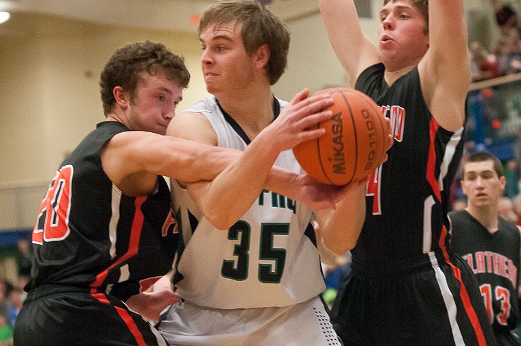 &lt;p&gt;Flathead junior Easton Johnson (20) reaches in on Glacier senior post Kevin Malloy (35) Friday night during the second half of Glacier's victory over Flathead at Glacier High School. March 7, 2014 in Kalispell, Montana. (Patrick Cote/Daily Inter Lake)&lt;/p&gt;