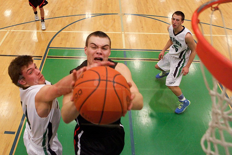 &lt;p&gt;Glacier senior guard Tanner Olsen (14) blocks the shot of Flathead senior Matt Quist (52) Friday night during Glacier's victory over Flathead at Glacier High School. March 7, 2014 in Kalispell, Montana. (Patrick Cote/Daily Inter Lake)&lt;/p&gt;