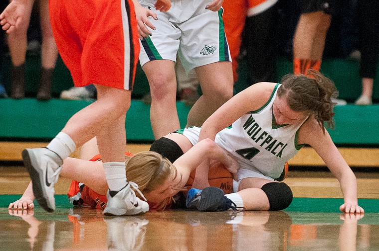 &lt;p&gt;Glacier sophomore guard Hailee Bennett (4) and Flathead senior Emma Andrews (10) fight for a loose ball Friday night during the second of half of Glacier's victory over Flathead at Glacier High School. March 7, 2014 in Kalispell, Montana. (Patrick Cote/Daily Inter Lake)&lt;/p&gt;