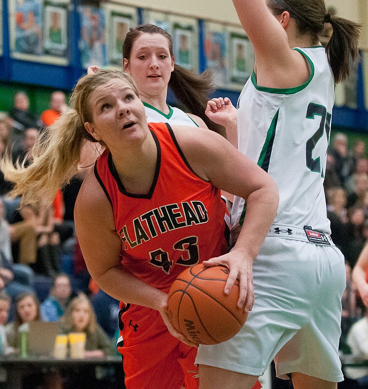 &lt;p&gt;Flathead senior Jenessa Heine (43) works around Glacier senior center Cassi Hashley (21) Friday night during the first of half of Glacier's matchup against Flathead at Glacier High School. March 7, 2014 in Kalispell, Montana. (Patrick Cote/Daily Inter Lake)&lt;/p&gt;