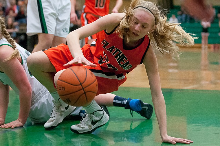 &lt;p&gt;Flathead sophomore Lizzie Sherwood (32) maintains her dribble while getting up after going to the ground Friday night during the second of half of Glacier's victory over Flathead at Glacier High School. March 7, 2014 in Kalispell, Montana. (Patrick Cote/Daily Inter Lake)&lt;/p&gt;