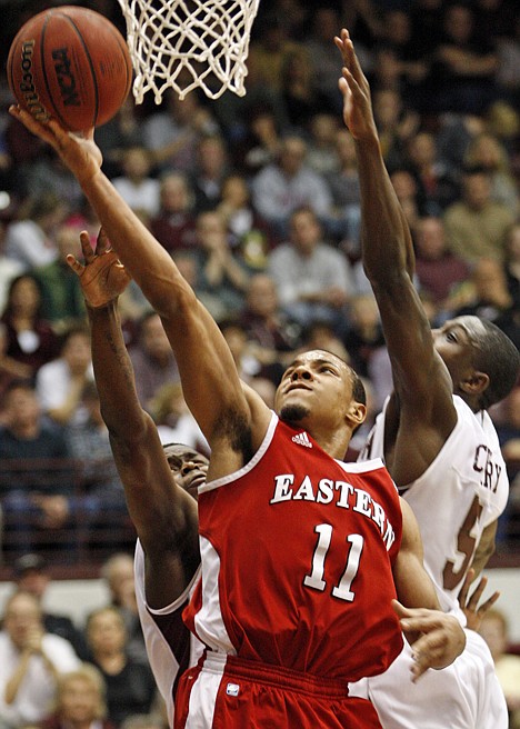 &lt;p&gt;Eastern Washington guard Cliff Colimon (11) shoots under the basket in front of Montana guard Keron DeShields, left, and guard Will Cherry (5) during the first half of an NCAA college Big Sky Tournament basketball game in Missoula, Mont., on Tuesday, March 6, 2012.(AP Photo/ Michael Albans)&lt;/p&gt;