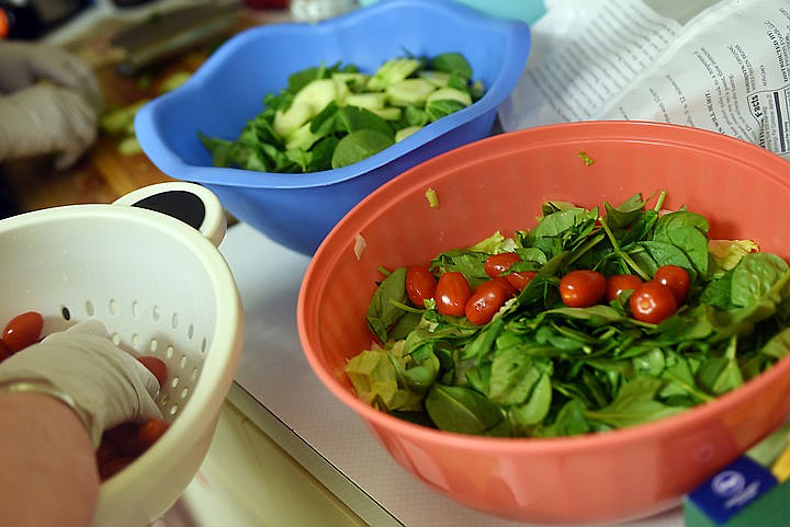 &lt;p&gt;Karene Manus adds tomatoes to a spinach salad as she and others prepare for the once-a-month community dinner at the Canyon Elementary School on Thursday, February 26, in Hungry Horse. Vera Smith said they prefer to make dishes that are fresh and organic whenever possible. (Brenda Ahearn/Daily Inter Lake)&lt;/p&gt;