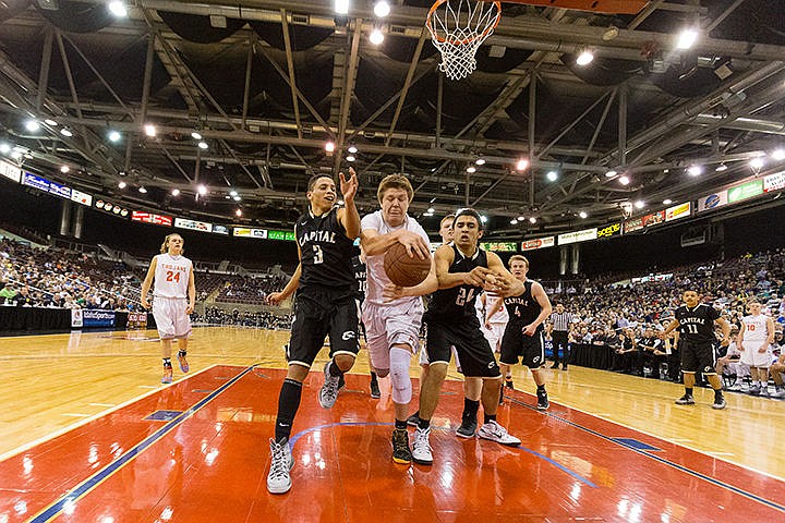 &lt;p&gt;Post Falls High School&#146;s Jack Millsap beats Capital High&#146;s Derrick White (3) and Cameron Godeny-Scott (24) for the rebound in the fourth quarter Friday during the state 5A boys basketball semi-final game against Capital High at the Idaho Center in Nampa.&lt;/p&gt;