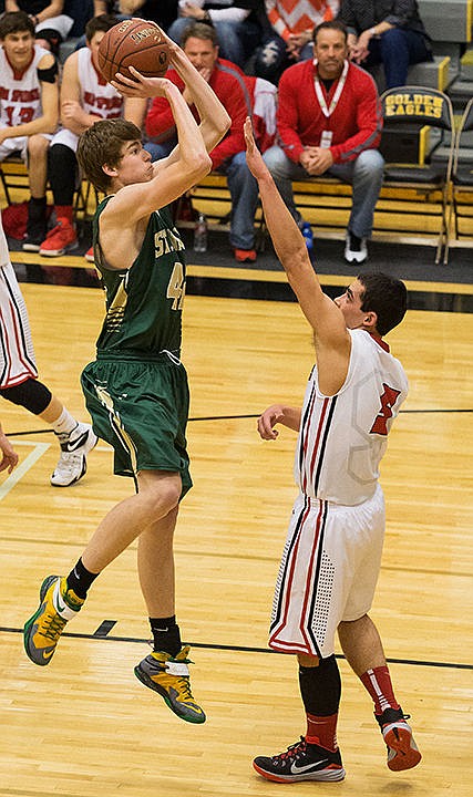 &lt;p&gt;St. Maries&#146; AJ Becktel puts up a first quarter score over Soda Springs&#146; Riley Yamauchi.&lt;/p&gt;