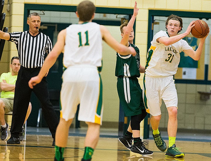 &lt;p&gt;Lakeland post Jau Plunkett moves around a Burley defender to make a pass in the first period on Friday.&lt;/p&gt;