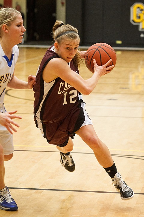 SHAWN GUST/Press

North Idaho College's Camille Reynolds drives to the hoop past a Salt Lake Community College defender in the first half.