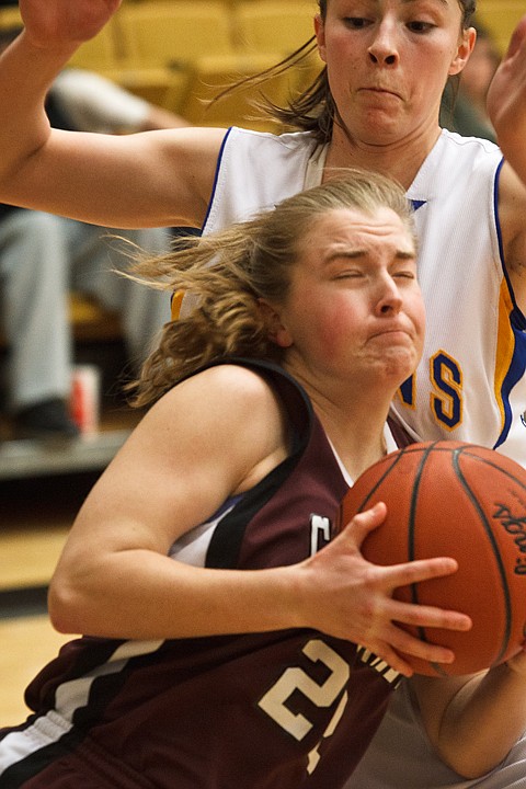 SHAWN GUST/Press

Amy  Warbrick, of North Idaho College, makes contact with Salt Lake Community College's Marissa Robbins during Region 18 women's basketball action.