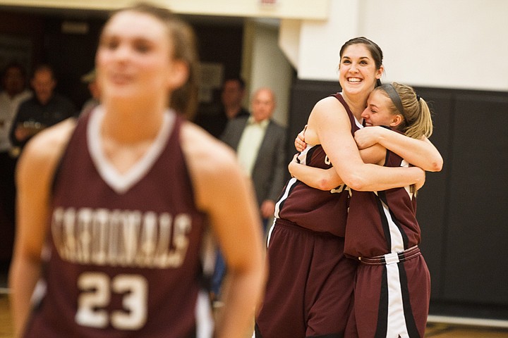 SHAWN GUST/Press

Deanna Dots hugs Camille Reynolds, right, in the final seconds of the Region 18 women's basketball tournament championship game as Korina Baker, foreground, prepares to shoot a free throw.