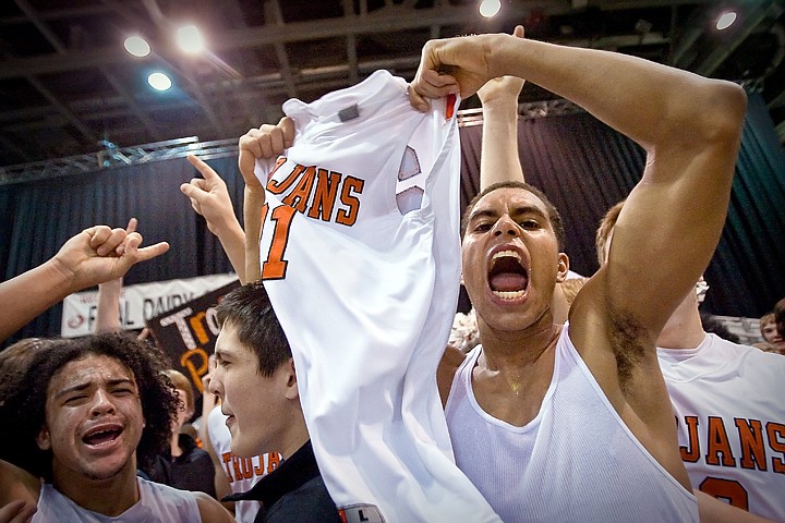 &lt;p&gt;Post Falls High's Shawn Reid, right, Scott Benner, Marcus Colbert celebrate the Trojan's first championship win since 1964 following the state 5A boys basketball championship game Saturday at the Idaho Center in Nampa.&lt;/p&gt;