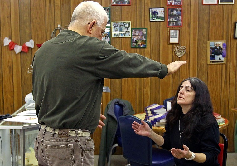 Gary Scheel prays for Terri Stevens during the Feb. 14 Harvest Fellowship service at Sykes&#146;.