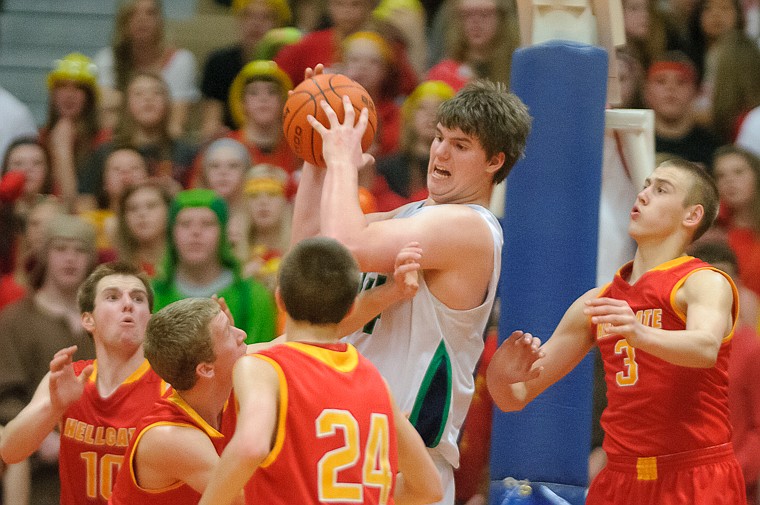 <p>Glacier senior post Ryan Edwards (44) secures a rebound Friday afternoon during Glacier's matchup against Hellgate on the second day of the Class AA state basketball tournament at Four Seasons Arena in Great Falls. Friday, March 8, 2013 in Great Falls, Montana. (Patrick Cote/Daily Inter Lake)</p>