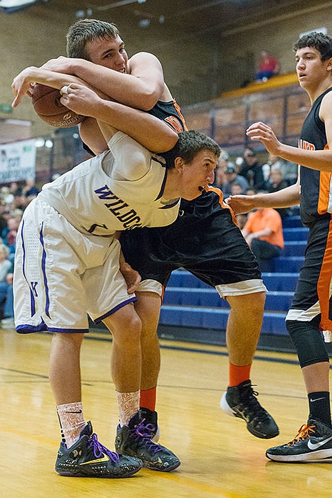 &lt;p&gt;Kellogg&#146;s Gus Colburn gets tangled up with Fruitland&#146;s Tyler Eiguren after going for a rebound in the first quarter of the state 3A boys basketball consolation game in Meridian.&lt;/p&gt;