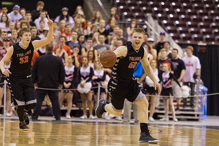 &lt;p&gt;Post Falls High School&#146;s Jacob Blakney dribbles the ball up the court as Jack Millsap gestures as time expires in overtime during the state 5A boys basketball tournament championship game against Highland High Saturday night at the Idaho Center in Nampa. Post Falls won the title with a score of 67-62.&lt;/p&gt;