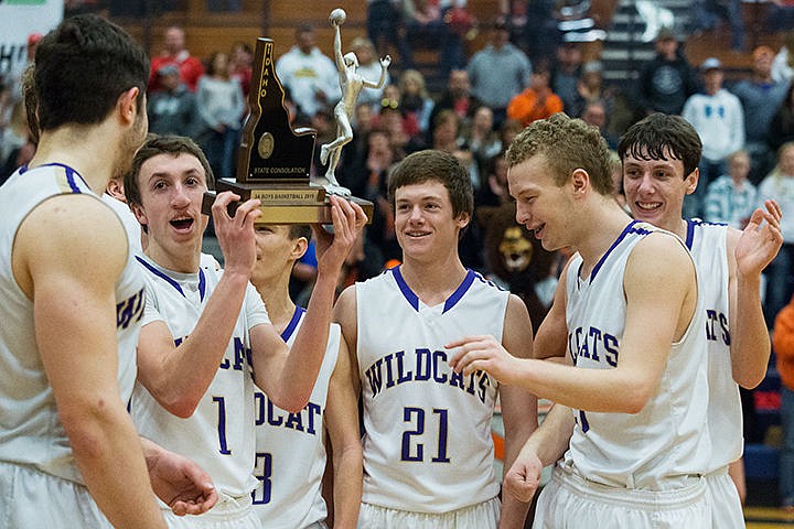 &lt;p&gt;Kellogg&#146;s Gus Colburn lifts the Wildcat&#146;s fourth place trophy while celebrating with his team after winning the state 3A boys basketball consolation round Saturday at Meridian High School in Meridian.&lt;/p&gt;