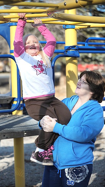 Ginny Larkey with her daughter Kemana, 5, of Evergreen playing at a park never East Evergreen Elementary school on Friday afternoon.