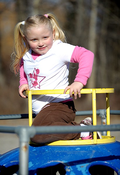 Kemana Larkey, 5, of Evergreen, plays at a park near East Evergreen Elementary School on Friday afternoon. Larkey has Blount&#146;s disease, a condition that causes her legs to bow. Whitefish Winter Classic funds helped her family travel to Spokane Shriner&#146;s Hospital for Kemana&#146;s orthopedic surgery and back and forth for appointments.