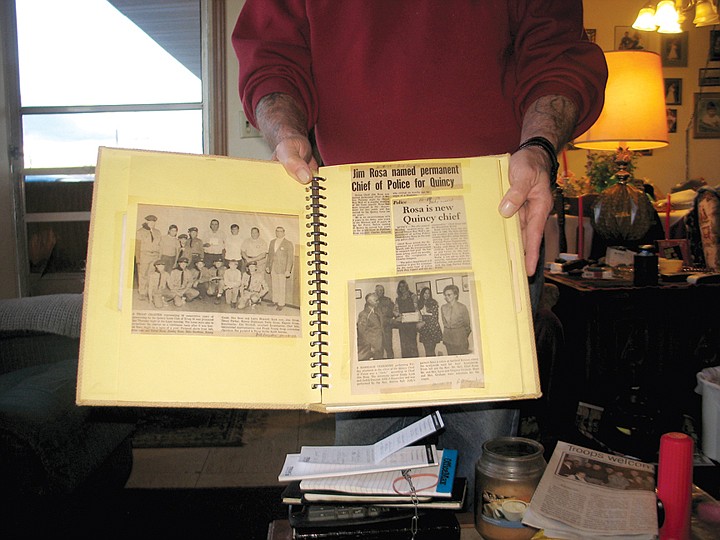 Chris Rosa holds newspaper clippings from his father's appointment as the Quincy police chief.