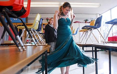 Columbia Falls freshman Kaitlyn Gehres spins around in her newly purchased refurbished prom dress in Mary Behrendt&#146;s classroom at the school on Wednesday. Gehres, who tried on several dresses, decided on this green gown costing $25. &#147;These dresses are so much cheaper. Some are like $250 dresses you can get for $25,&#148; Gehres said. &#147;And it&#146;s fun to make up things that no one has ever worn before,&#148; she said of customizing her dress. &lt;br&gt;Prom couture at a cut-rate price&lt;br&gt;Apparel class sells elegance for less
