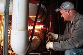 Sam Deschamps of Plains who is a boiler maker by trade, volunteered his time at the Plains community pool boiler room on Wednesday to remove the pool's thirty year old sand filter.  Plains community members are teaming up to try to raise money and get the filter replaced.  &quot;The pool cannot function without a new filter,&quot; said Deschamps.  Deschamps was working on the filter with Jon Dubois.  They are both parents of kids on the swim team in Plains, and are removing the filter now, so that if and when there is money for new one, it can be installed immediately.