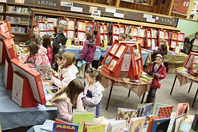 Third graders at Plains elementary school looked at books at the Scholastic Book Fair at the high school library on Thursday morning.  Schools across Montana are celebrating &quot;I Love to Read Month,&quot; which was in February, but they are celebrating their reading accomplishments now.