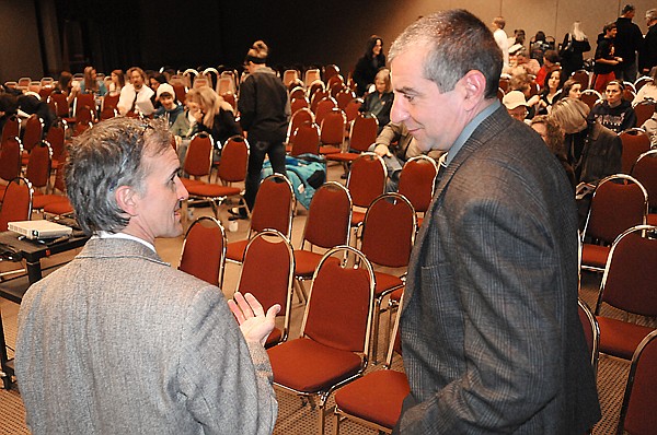 John Underwood, founder and president of the American Athletic Institute, left, speaks with Flathead County Sheriff Chuck Curry on Tuesday night and the audience begins to arrive for the Stop Underage Drinking in the Flathead Coalition town hall meeting.