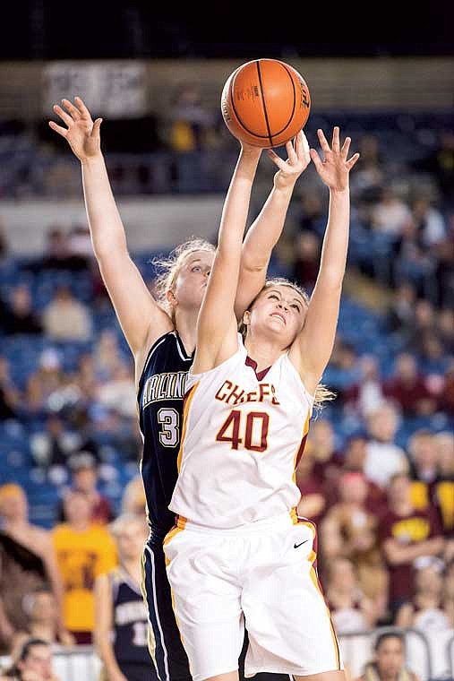 Moses Lake senior Kaitlyn Stevens skies for a rebound against an Arlington defender.