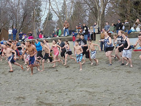 &lt;p&gt;Nearly 40 people charge into the icy lake water during the &quot;Plunging for Pesos&quot; fundraiser at the Coeur d'Alene City Beach on Saturday morning.&lt;/p&gt;