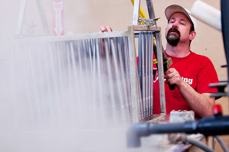 &lt;p&gt;Ed Thielman, manager of the gun barrel processing facility, lowers a rack of barrels into a manganese phosphate bath Tuesday afternoon at Armor Anodizing. March 4, 2014 in Kalispell, Montana. (Patrick Cote/Daily Inter Lake)&lt;/p&gt;