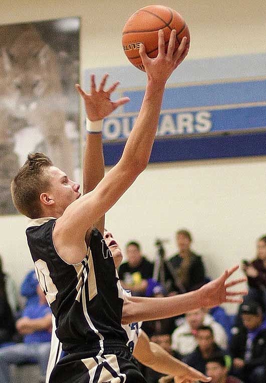 Corbin Christensen puts his 6-2 frame to use as he beats a Warden defender to the basket. He returns next season fo rthe Knights.