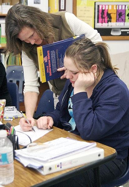 Canda Harbaugh/The Western News Math teacher Linda Shilling helps Lexii Combs with her homework Tuesday after school. One way the school works to prevent students from dropping out is to offer help and credit-recovery after school.
