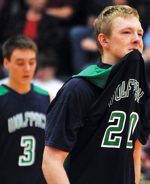 Glacier's Colter Hansen (20) walks off the court with his jersey in his mouth after a narrow loss in overtime.