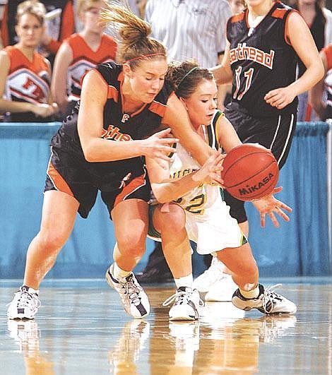 Associated Press &lt;br&gt;Flathead's Holli Hashley and Great Falls CMR's Kassie Holmlund, right, collide as they scramble for a loose ball during &lt;br&gt;first-round action Thursday at the Class AA state basketball tournament in Billings. CMR beat Flathead 69-55.